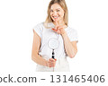 Studio portrait of woman with magnifying glass 131465406