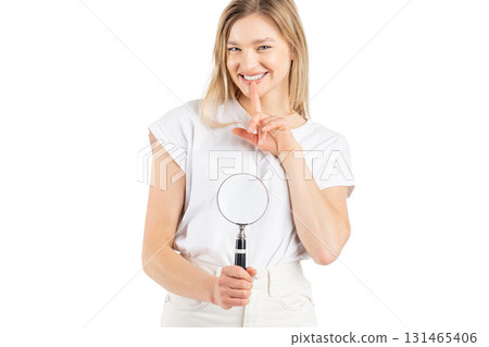 Studio portrait of woman with magnifying glass Studio portrait of woman with magnifying glass 131465406
