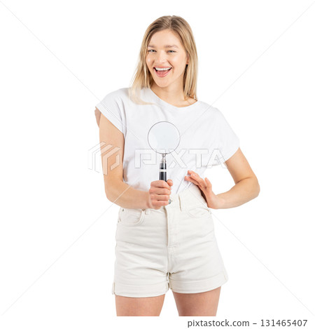 Studio portrait of woman with magnifying glass 131465407