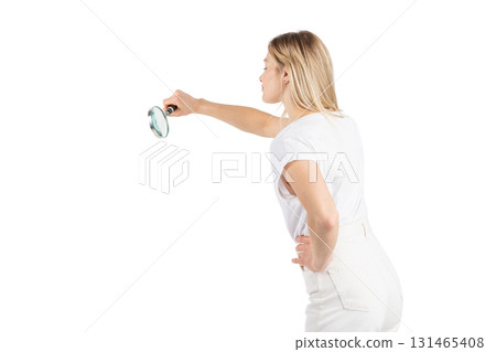 Studio portrait of woman with magnifying glass 131465408