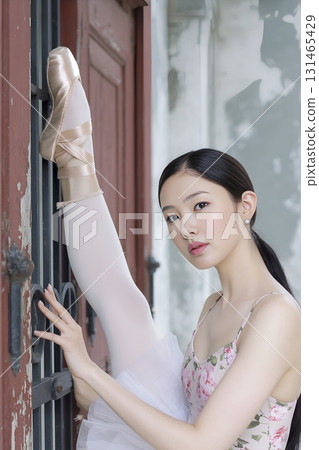 Woman in a white dress is posing for a picture 131465429