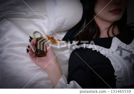 A landmine girl lying on the bed with medicine 131465539