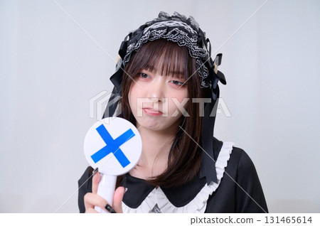 A woman holding a circle and a cross 131465614