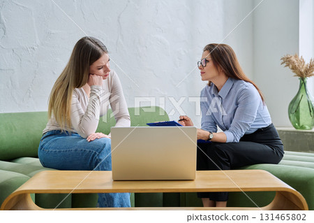 Young female patient during psychotherapy session with psychologist Young female patient during psychotherapy session with psychologist 131465802