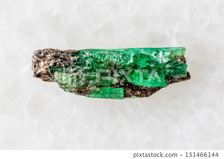 sample of unworked emerald crystal on white 131466144
