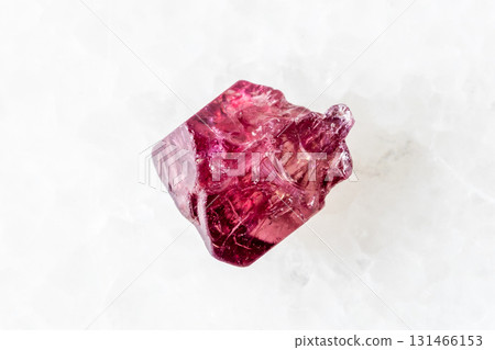 sample of raw red spinel crystal on white marble 131466153