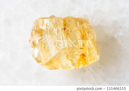 sample of raw yellow scapolite crystal on white 131466155