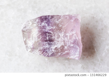 unworked purple striped fluorite mineral on white 131466229
