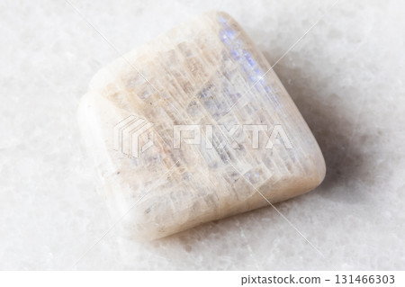 polished belomorite moonstone rock on white marble 131466303
