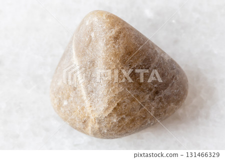 sample of tumbled cryolite rock on white marble sample of tumbled cryolite rock on white marble 131466329