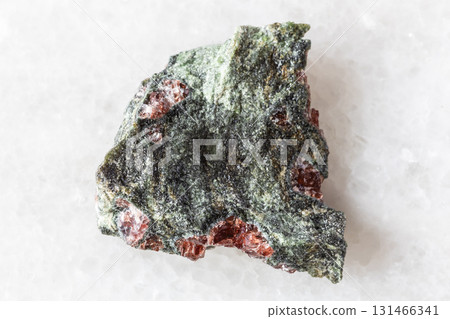 sample of pyrope garnets in rough rock on white 131466341