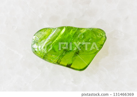 tumbled chromian diopside mineral on white marble 131466369