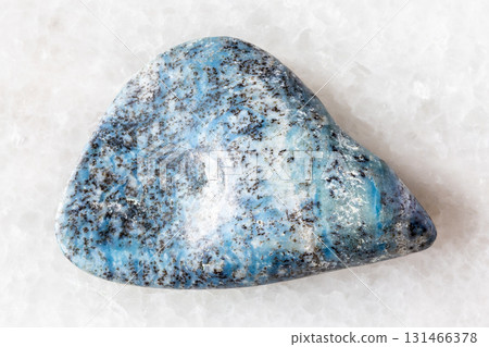 sample of tumbled dianite rock on white marble 131466378