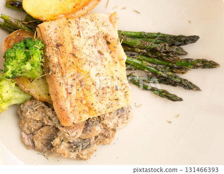 dish of fried river trout fillet with garnish of broccoli, asparagus sprouts and mushroom sauce dish of fried river trout fillet with garnish of broccoli, asparagus sprouts and mushroom sauce 131466393