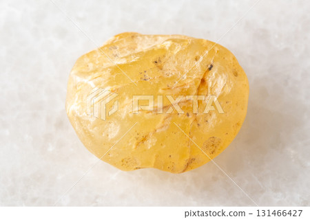 sample of raw cornelian mineral on white marble 131466427