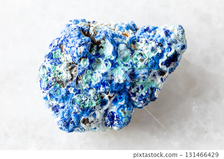 raw azurite and gibbsite mineral on white marble 131466429