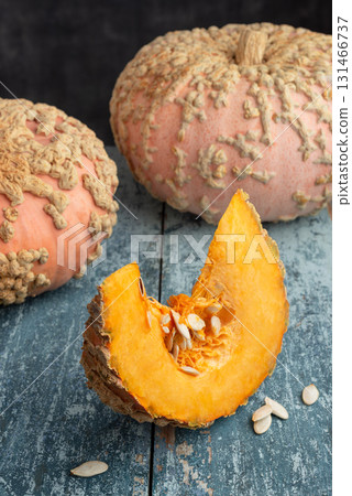 Galeux d Eysines Pumpkin Slice With Seeds On Rustic Table Galeux d Eysines Pumpkin Slice With Seeds On Rustic Table 131466737