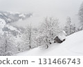 Snowy Winter Landscape With Old Wooden Cabin In Foggy Mountain Village 131466743