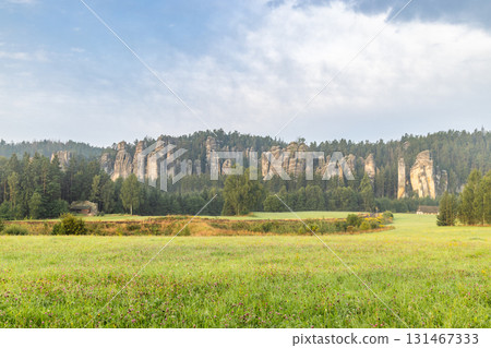 Landscape of Adrspach-Teplice Rocks area, in Hradec Kralove Region in Czech Republic, Europe. Scenic landscape featuring rock formations and lush greenery under cloudy sky. Peaceful countryside view. Landscape of Adrspach-Teplice Rocks area, in Hradec Kralove Region in Czech Republic, Europe. Scenic landscape featuring rock formations and lush greenery under cloudy sky. Peaceful countryside view. 131467333