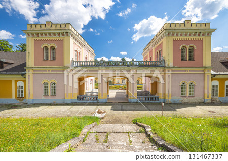 Hodkovce Mansion in Zehra village in Slovakia, Europe. Symmetrical architecture and stone steps beneath a sunny sky, showcasing a historic edifice with an archway entrance. Hodkovce Mansion in Zehra village in Slovakia, Europe. Symmetrical architecture and stone steps beneath a sunny sky, showcasing a historic edifice with an archway entrance. 131467337
