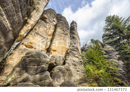 Adrspach-Teplice Rocks, sandstone formations in Hradec Kralove Region in the Czech Republic, Europe. Striking sandstone formations tower high, carved by time and weather, creating a surreal landscape. Adrspach-Teplice Rocks, sandstone formations in Hradec Kralove Region in the Czech Republic, Europe. Striking sandstone formations tower high, carved by time and weather, creating a surreal landscape. 131467372