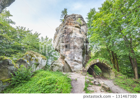Landscape of Adrspach-Teplice Rocks area, in Hradec Kralove Region in the Czech Republic, Europe. Unique rock formation with carved steps and an arch, surrounded by green trees and a path in nature. Landscape of Adrspach-Teplice Rocks area, in Hradec Kralove Region in the Czech Republic, Europe. Unique rock formation with carved steps and an arch, surrounded by green trees and a path in nature. 131467380