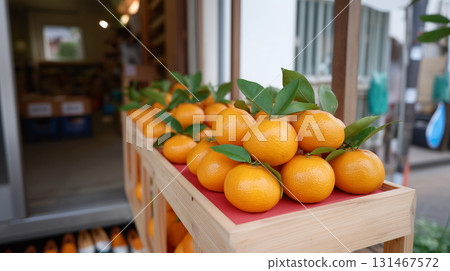 Fresh oranges with green leaves displayed in wooden crate at local market Fresh oranges with green leaves displayed in wooden crate at local market 131467572