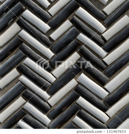 Close up of herringbone pattern made from bamboo strips dyed in charcoal and cream, creating textured and stylish design. alternating colors add depth and contrast 131467653