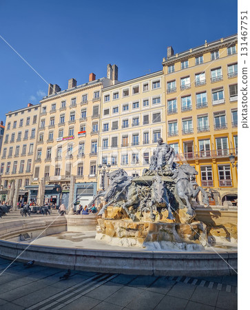 Lyon, France - February 13, 2024 The Fontaine Bartholdi, a monumental bronze sculpture at the Place des Terreaux in Lyon. The fountain depicts a female on a chariot with four great rivers of France Lyon, France - February 13, 2024 The Fontaine Bartholdi, a monumental bronze sculpture at the Place des Terreaux in Lyon. The fountain depicts a female on a chariot with four great rivers of France 131467751