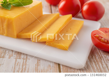 Sheddar cheese slices close-up. 131468032