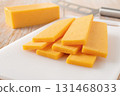 Sliced cheddar cheese close-up. 131468033