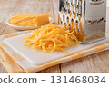 Grated cheddar cheese close-up. 131468034