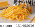 Shredded cheddar cheese close-up. 131468036