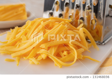 Shredded cheddar cheese close-up. 131468036
