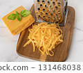 Whole and shredded cheddar cheese close-up. 131468038