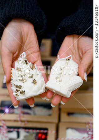 White candle souvenirs in the shape of a mitten and a pine cone White candle souvenirs in the shape of a mitten and a pine cone 131468187