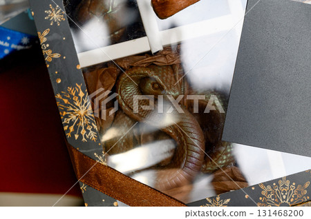 A close-up of a handmade chocolate gift box in the shape of a snake. 131468200