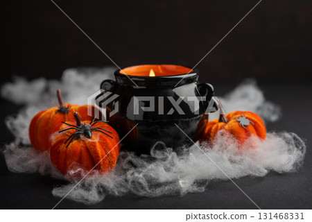 Halloween Candle in Cauldron with Pumpkins and Fog Halloween Candle in Cauldron with Pumpkins and Fog 131468331