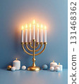 Menorah with lit candles against a blue wall background 131468362
