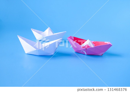 Leadership concept.Group of origami boats on blue. Leadership concept.Group of origami boats on blue. 131468376
