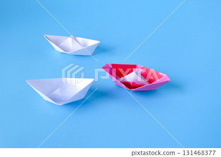 Leadership concept.Group of origami boats on blue. Leadership concept.Group of origami boats on blue. 131468377