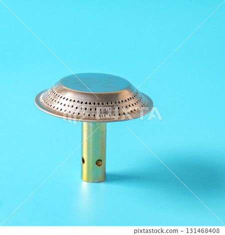 Spares part of steel metal gas burner head on background. Spares part of steel metal gas burner head on background. 131468408