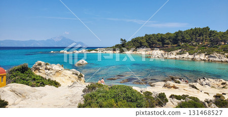 wild beach on the seashore. clean and soft sand, clear water and big stones 131468527