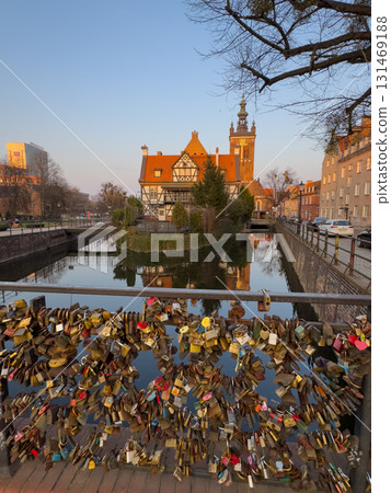Bridge with love locks overlooking historic Gdansk architecture and water reflections Bridge with love locks overlooking historic Gdansk architecture and water reflections 131469188