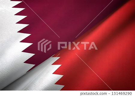 Close up of qatar and bahrain flags with textured fabric and angled presentation style 131469290