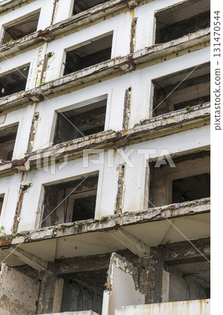 Facade of the abandoned high rise building construction site 131470544