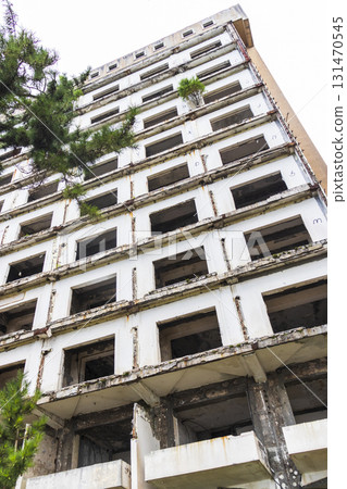 Facade of the abandoned high rise building construction site 131470545