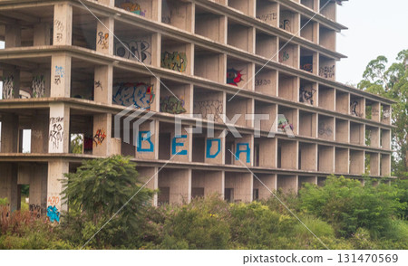 09.09.2025 - Kobuleti, Georgia - Abandoned, incomplete construction site of the high rise building with graffiti on the walls 131470569
