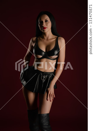 Woman showcasing leather accessories in a studio setting 131470871