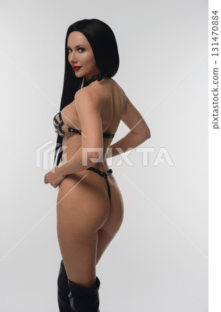 Woman showcasing leather accessories in a studio setting Woman showcasing leather accessories in a studio setting 131470884